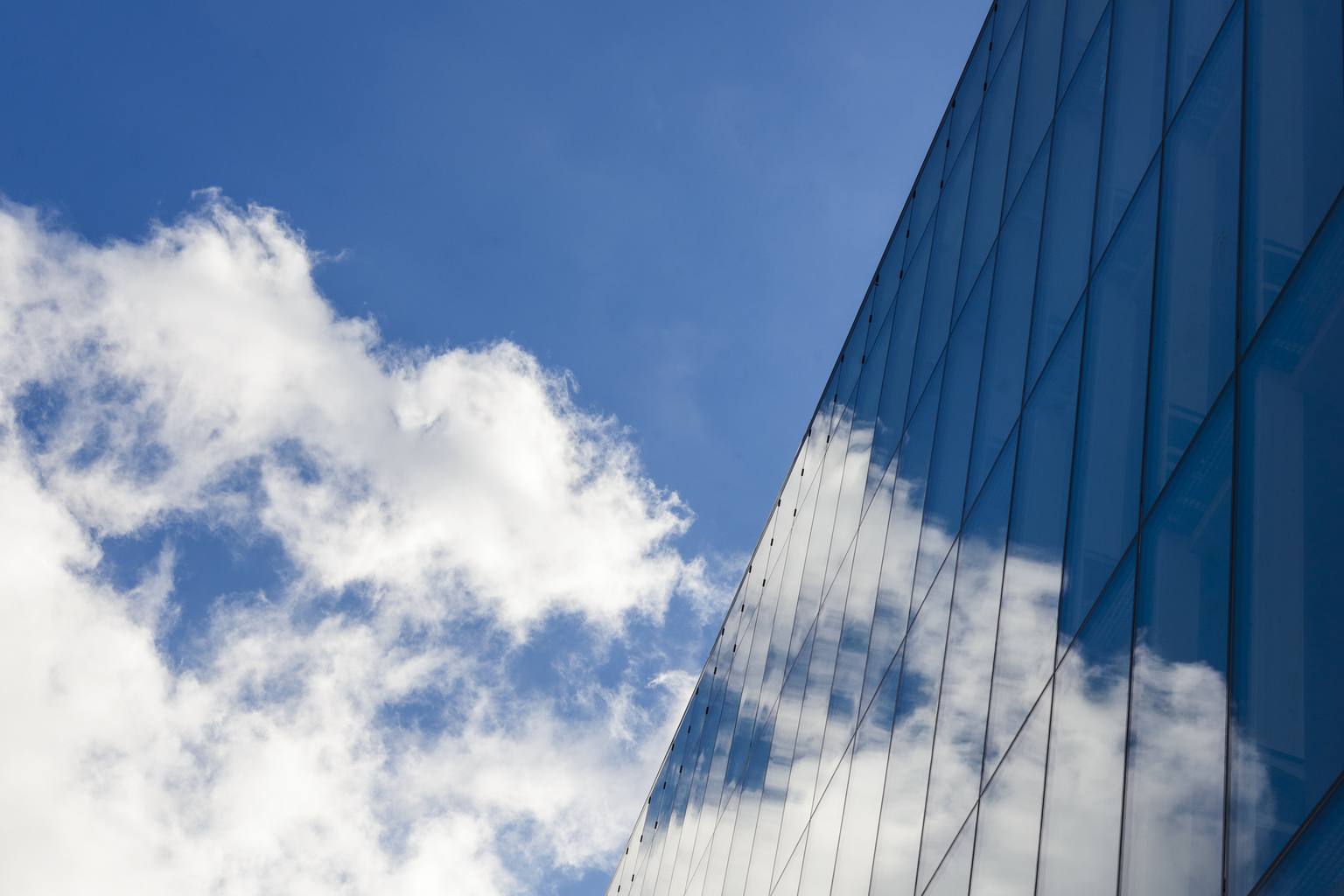 Cloud reflecting in modern building, Molndal, Vastergotland, Sweden,