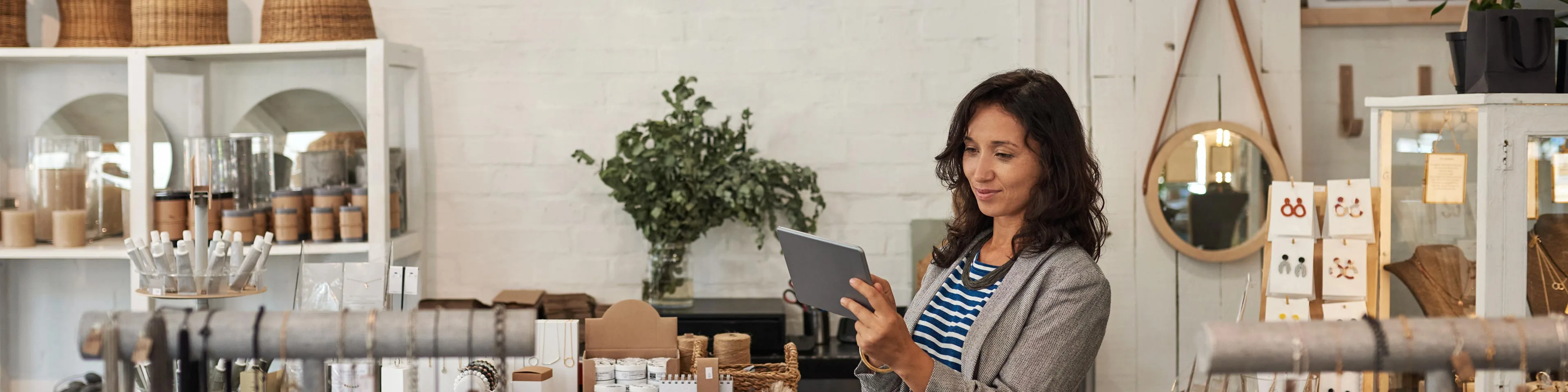 A businesswoman in her retail shop determining business license needs
